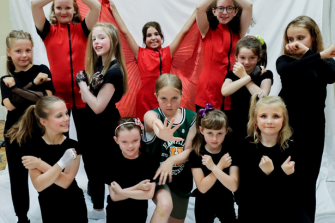 Girls in black tops or red vest with red veil wings